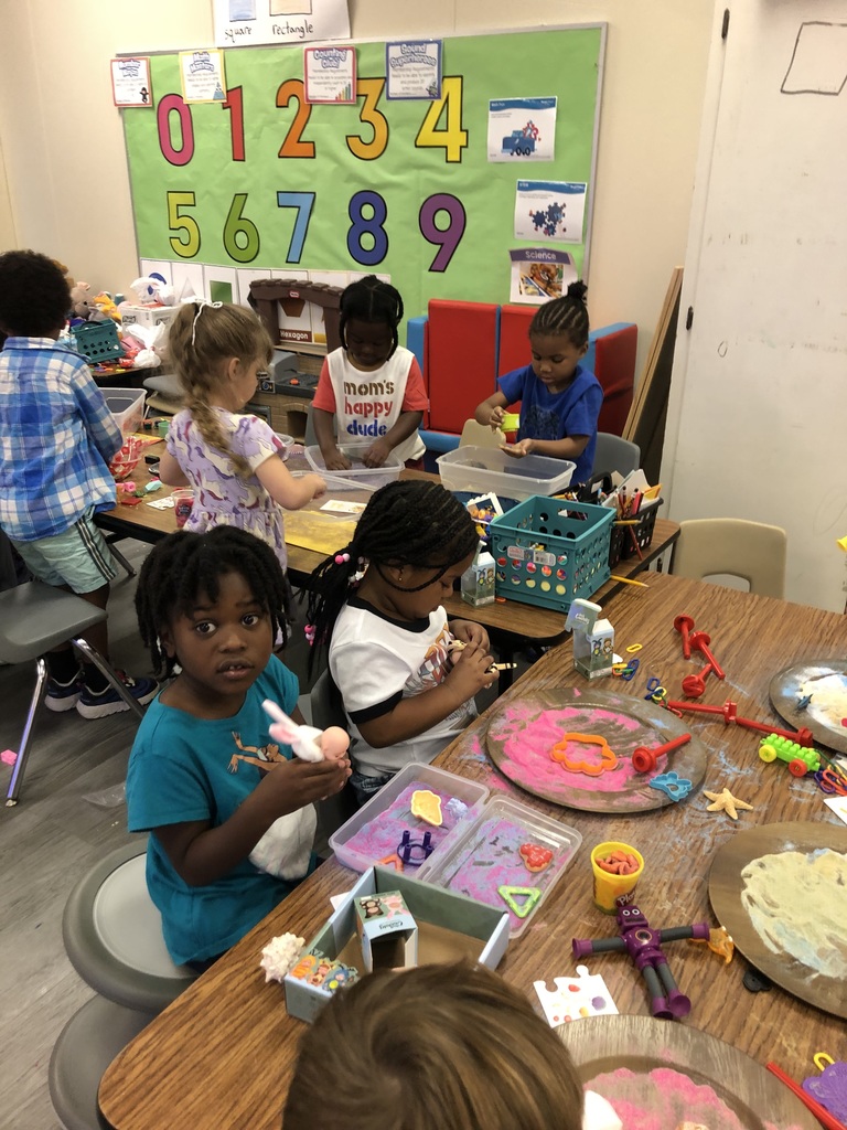 students playing with sand and objects