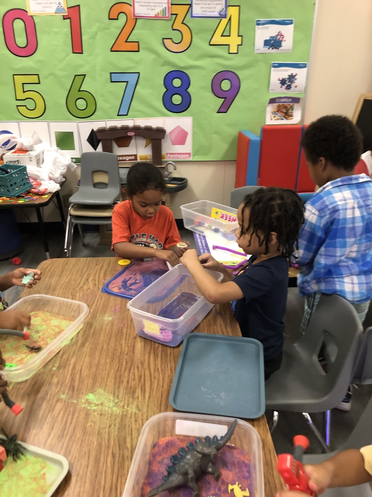 students playing with sand and objects
