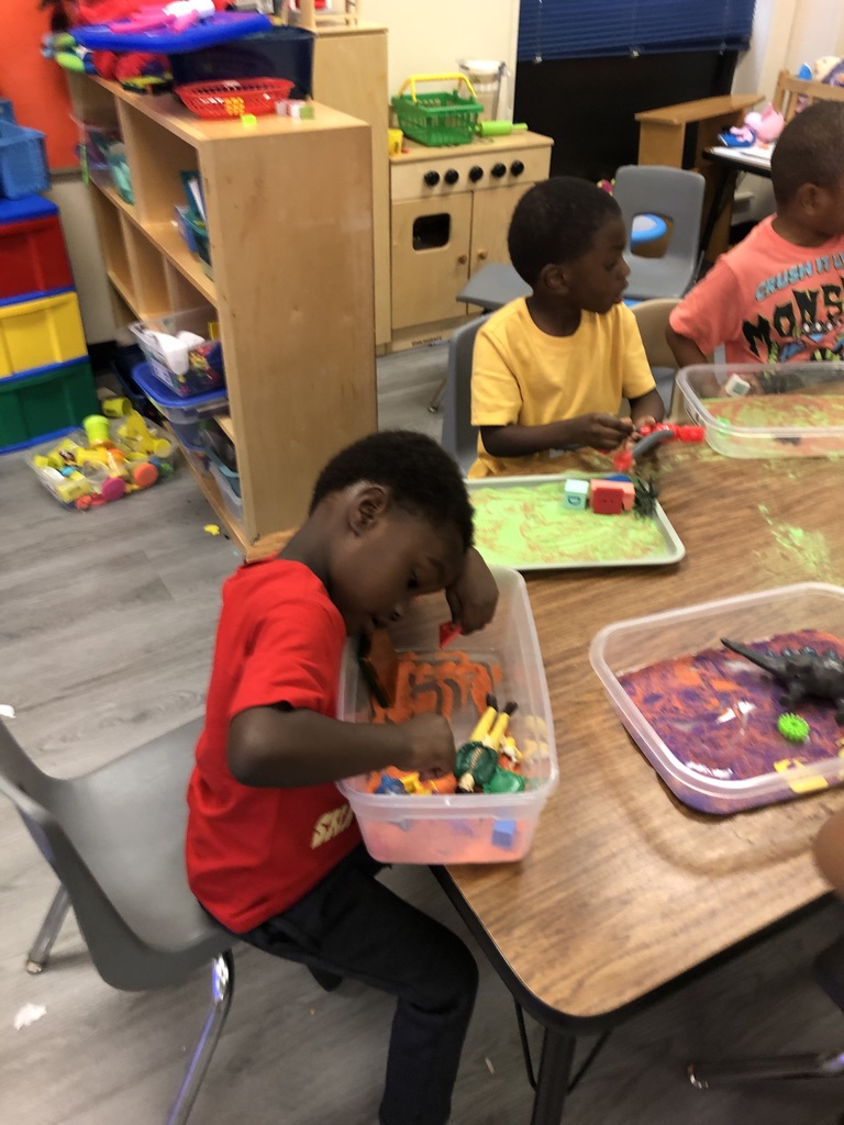 students playing with sand and objects