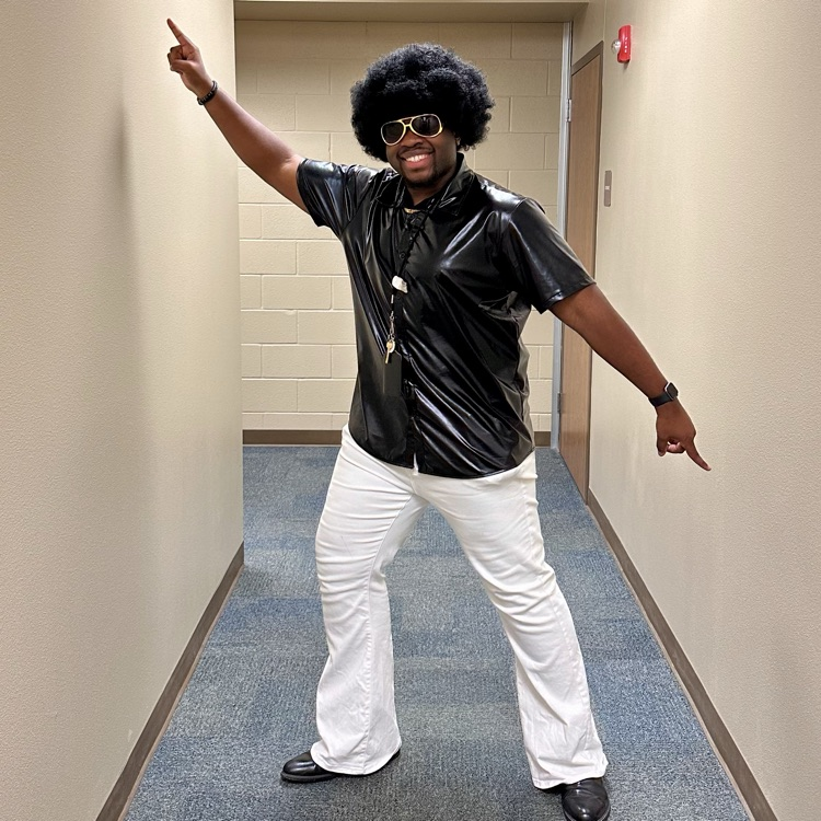 man in a disco stance