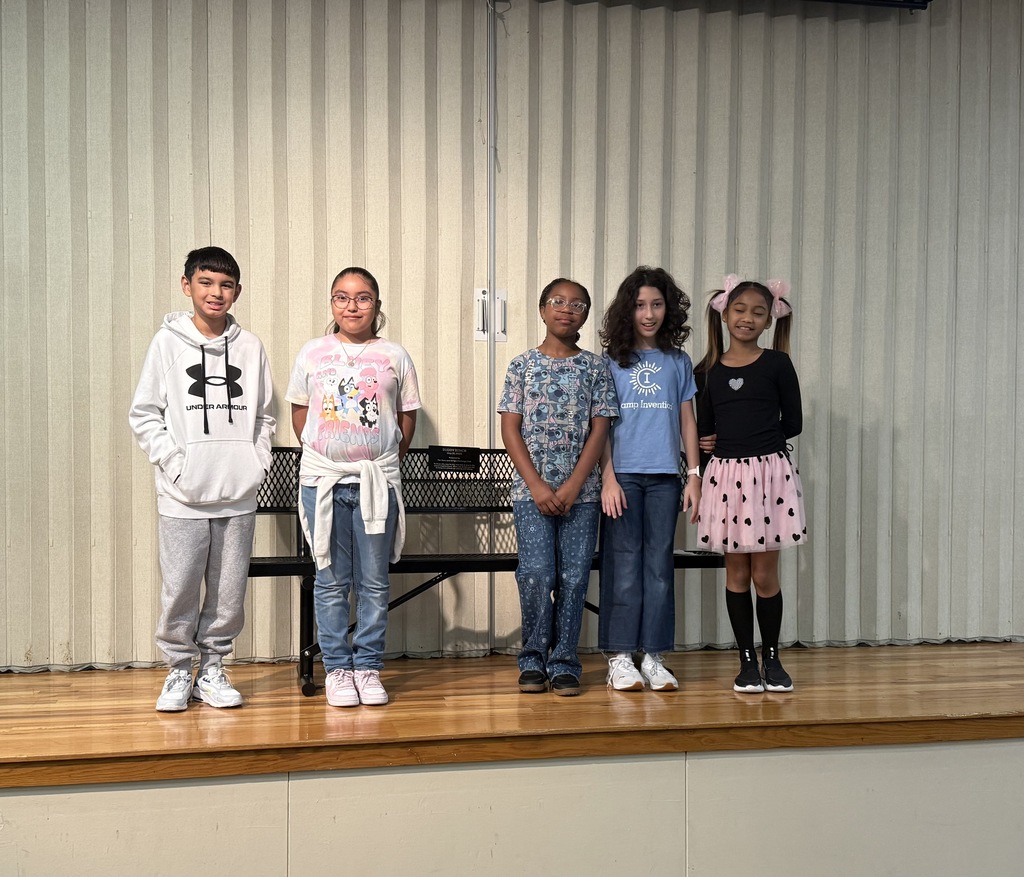 Students standing with a bench