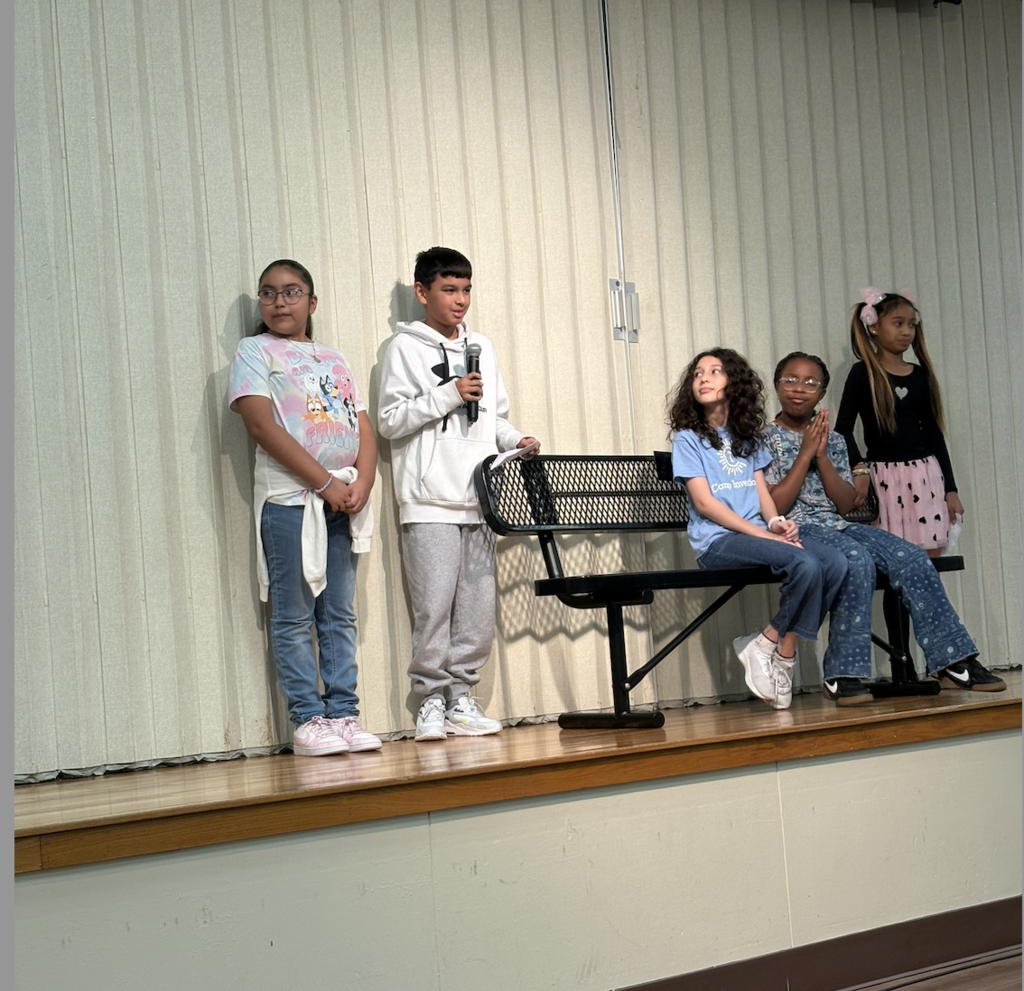 Students standing with a bench
