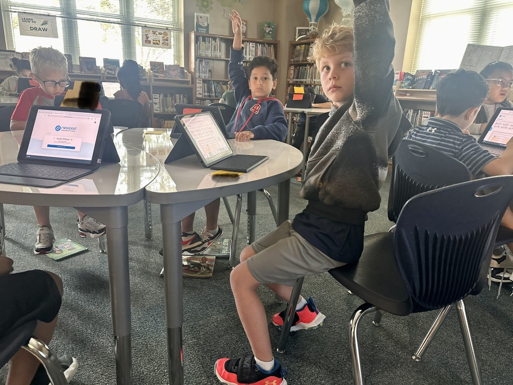 photo of students with their hands up