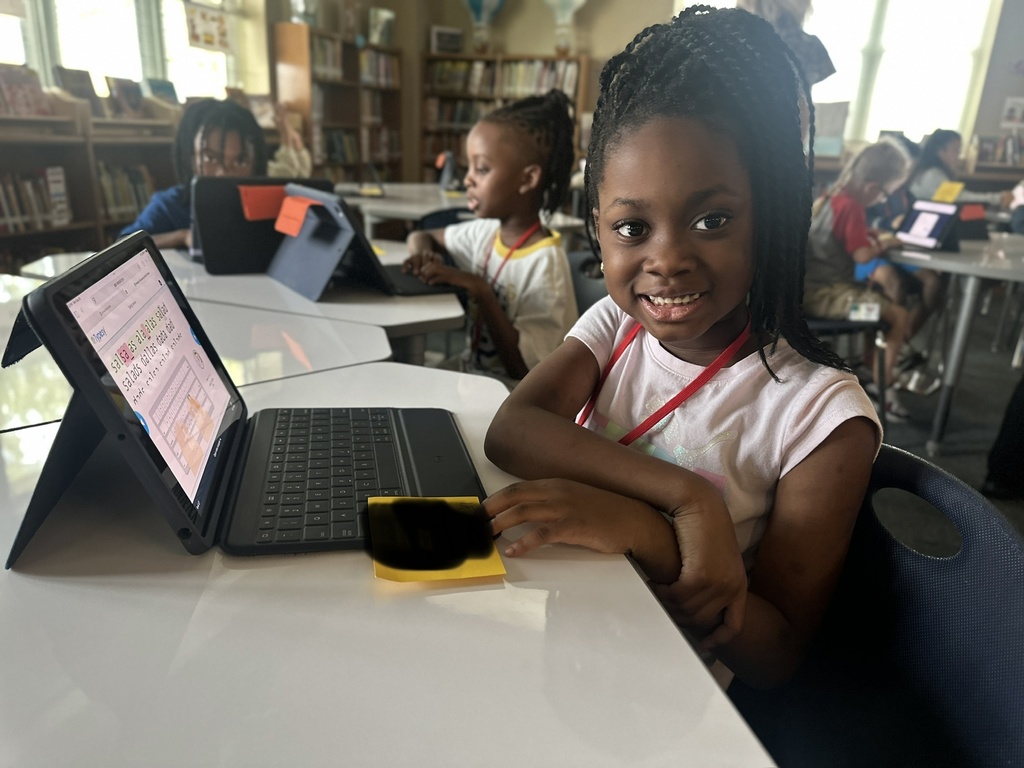 students smiling and typing