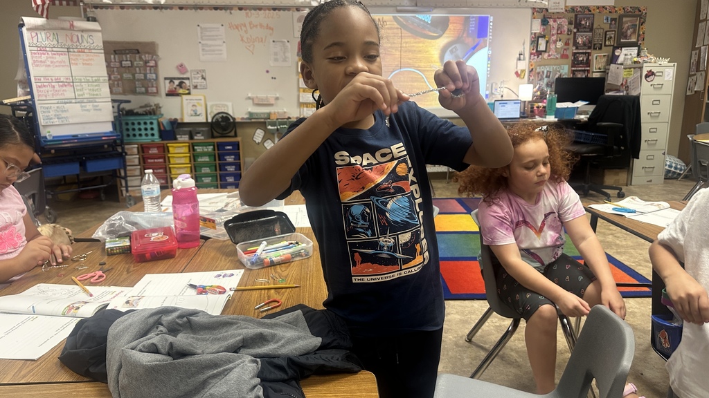 student playing with magnet and object