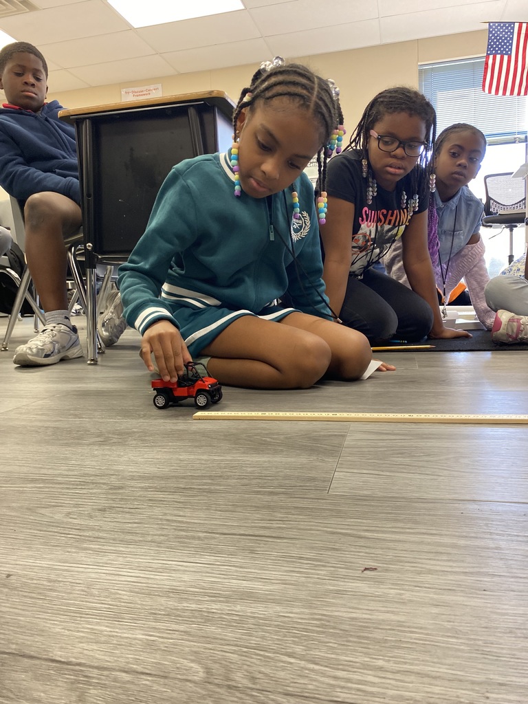student rolling car for experiment