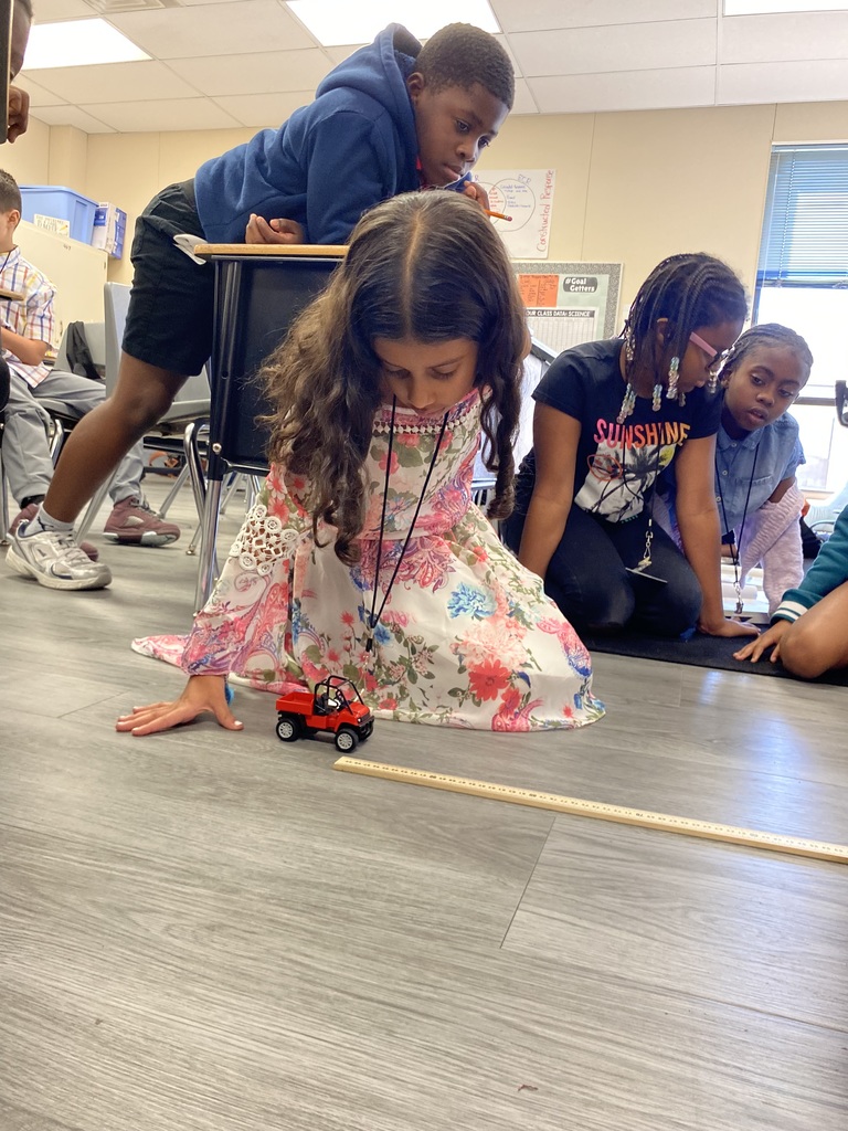 student rolling car for experiment