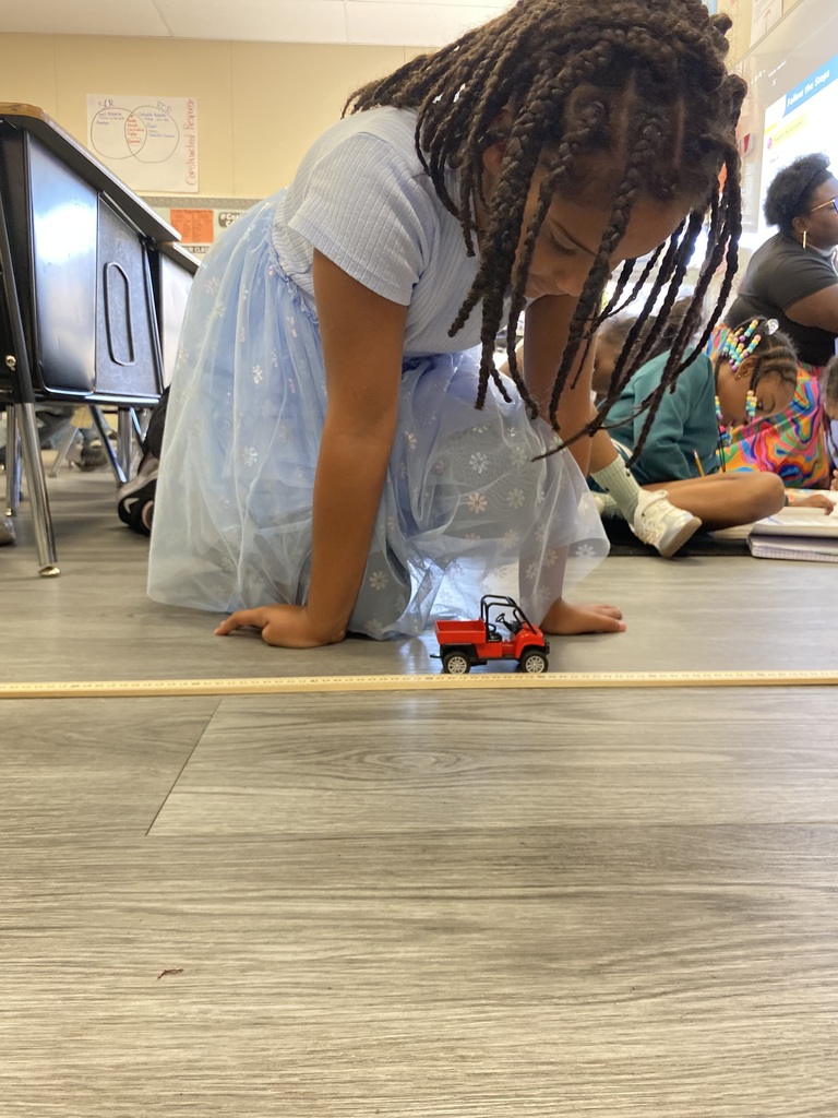 student rolling car for experiment