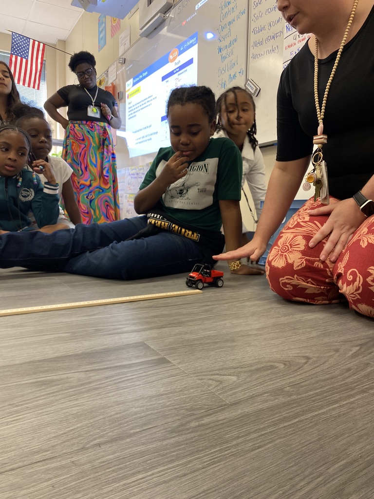 student and teacher rolling car for experiment