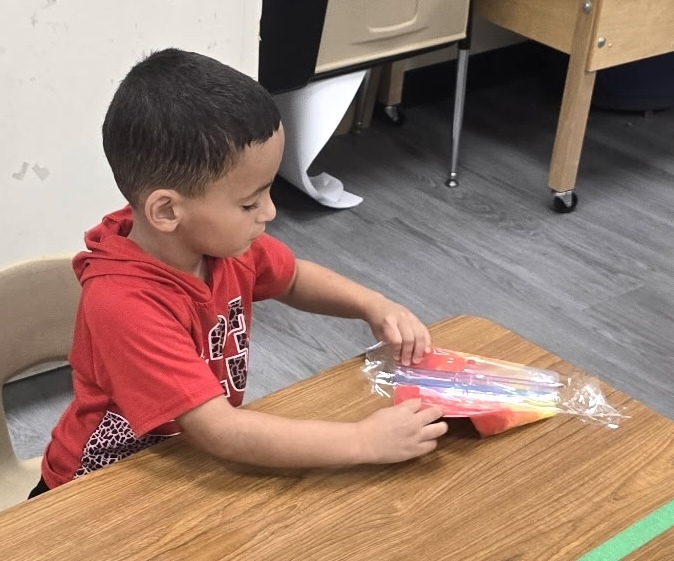 students playing with sensory bags of paint