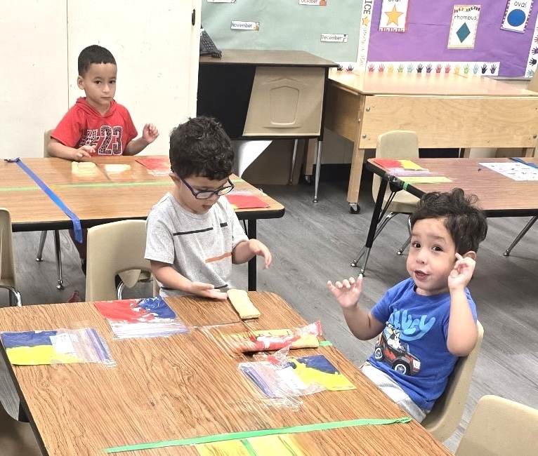 students playing with sensory bags of paint