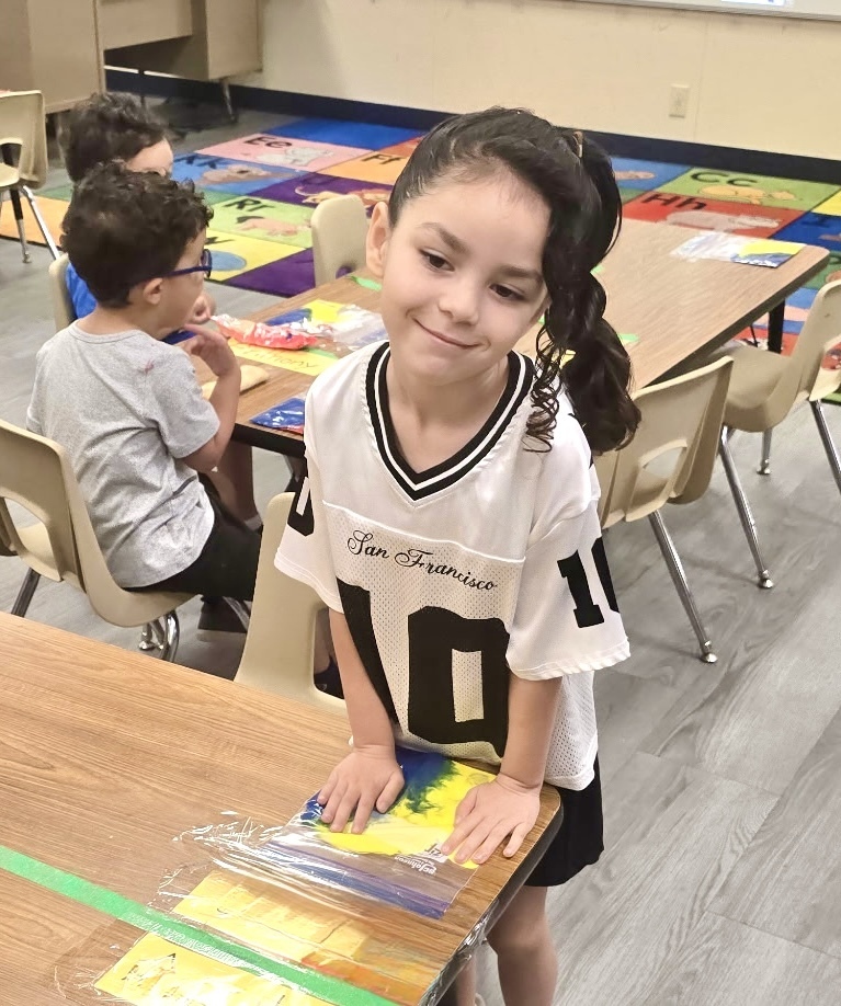 students playing with sensory bags of paint