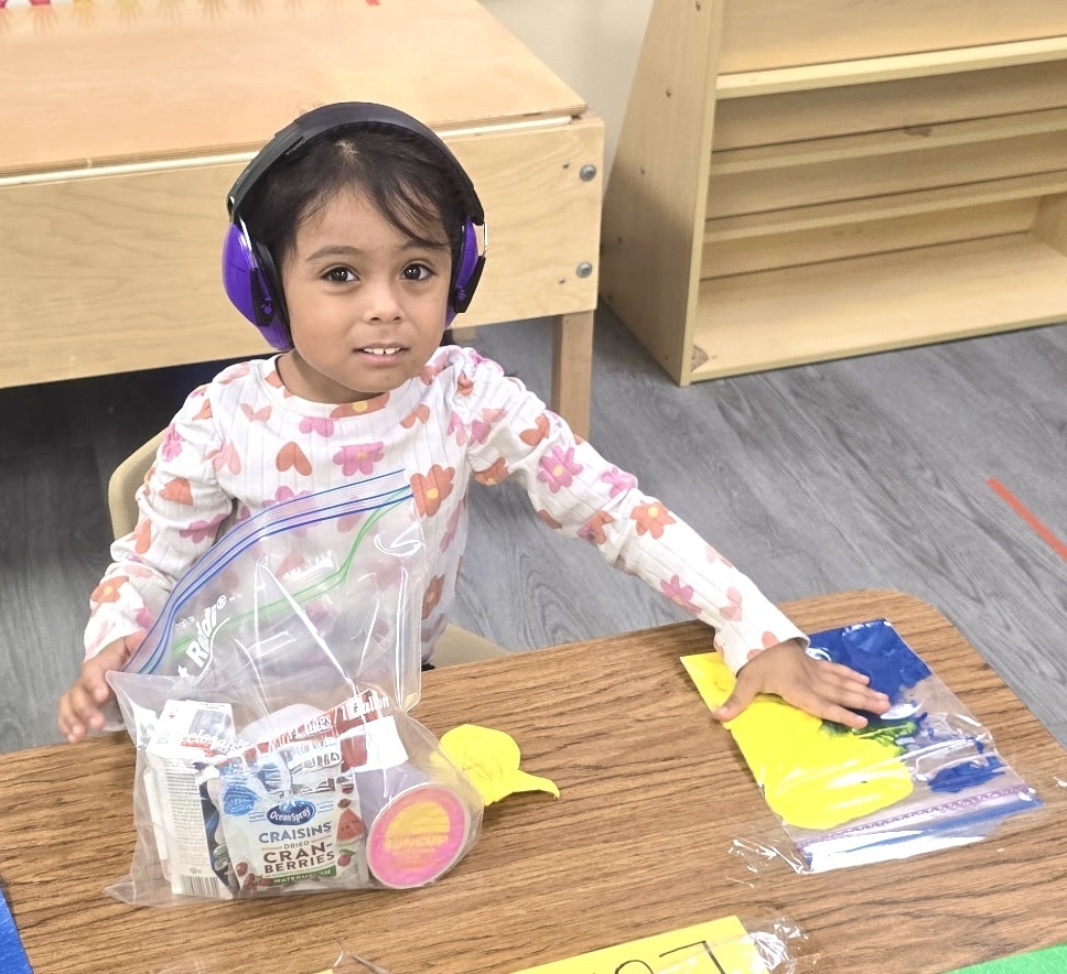 students playing with sensory bags of paint