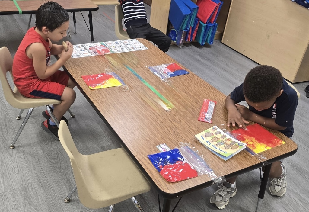 students playing with sensory bags of paint