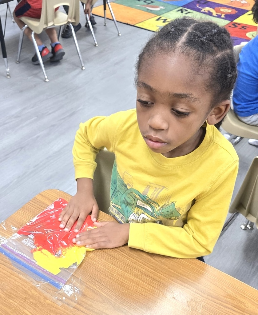 students playing with sensory bags of paint