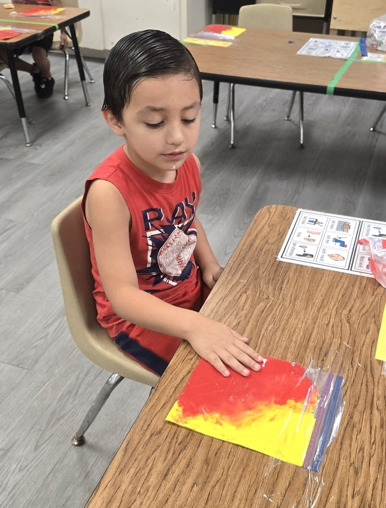 students playing with sensory bags of paint