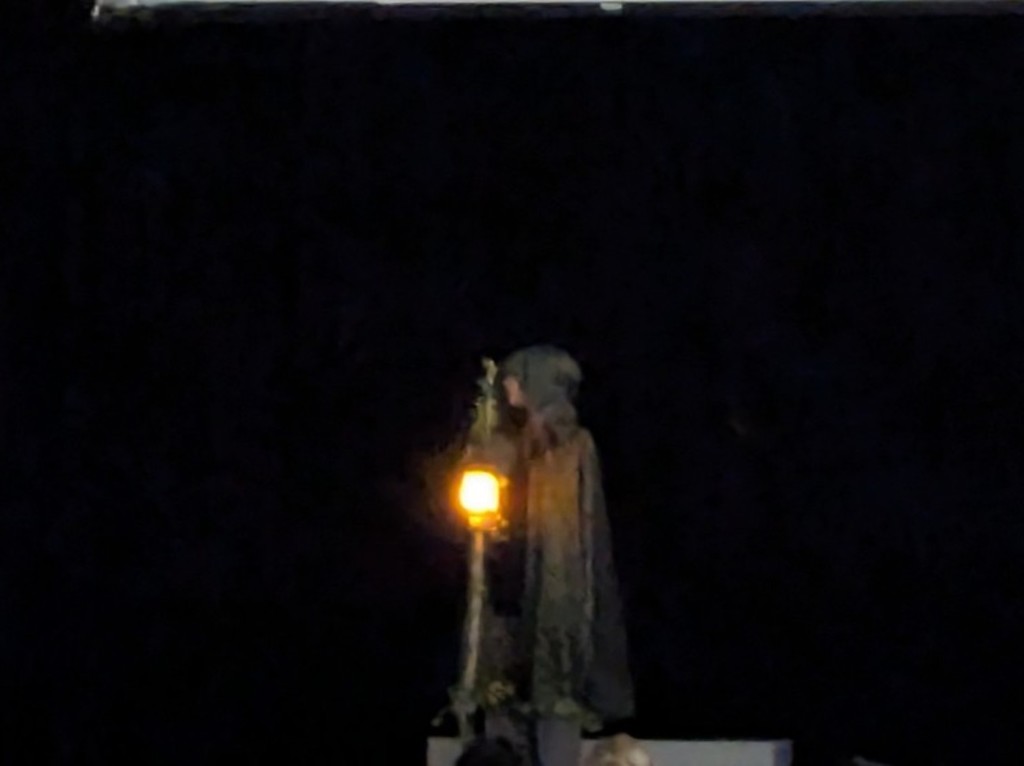 hooded figure with the light
