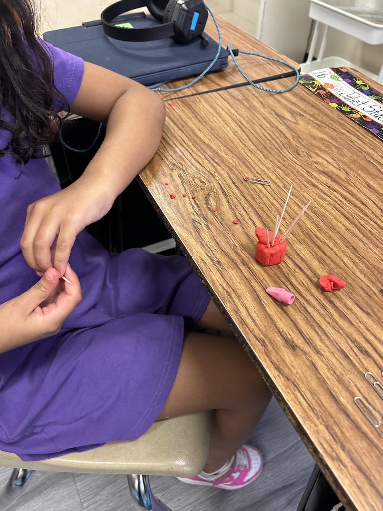 students using clay to create new objects