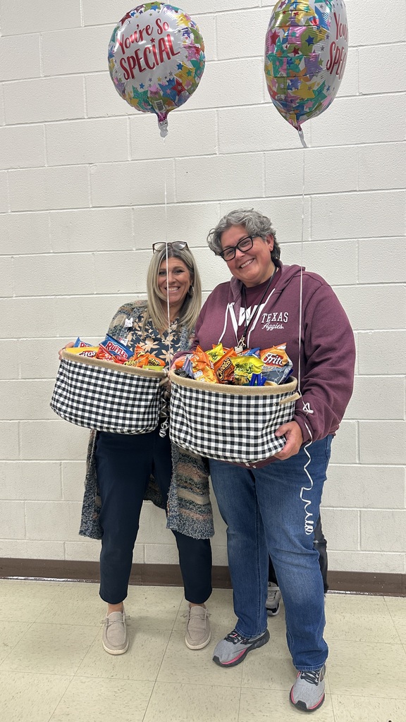 Mrs Howley and Mrs Jenkins holding gift baskets 