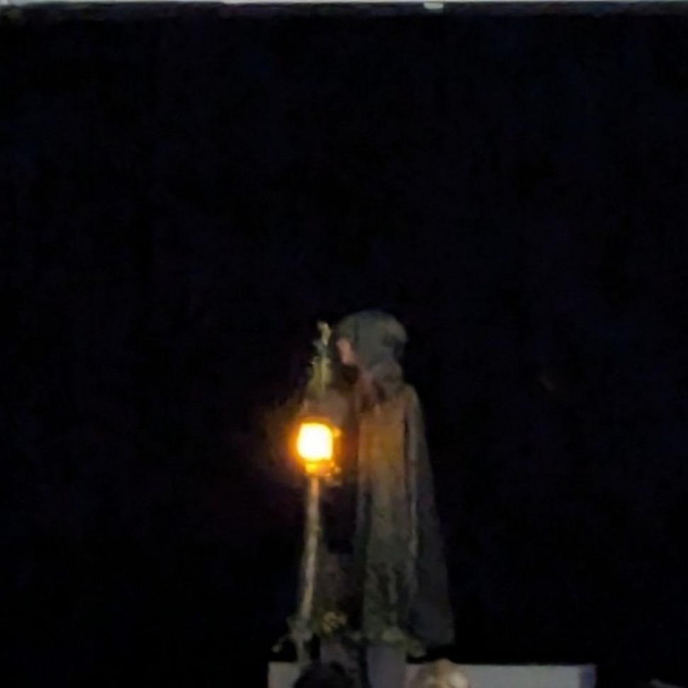 hooded figure with the light