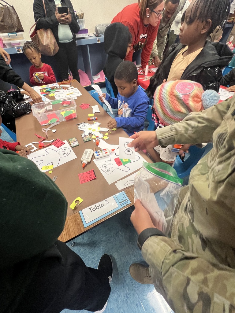 Soldiers helping with reading activity.