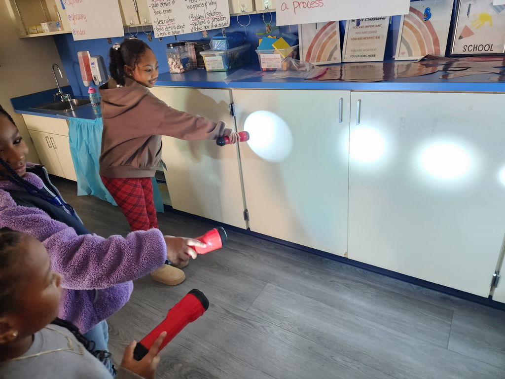 students with flashlights