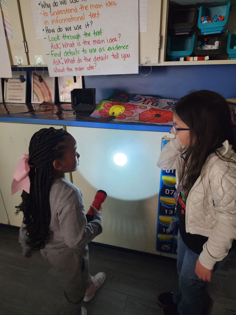 students with flashlights