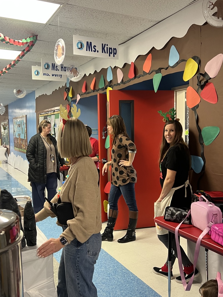Teachers in the hallway getting hot cocoa.
