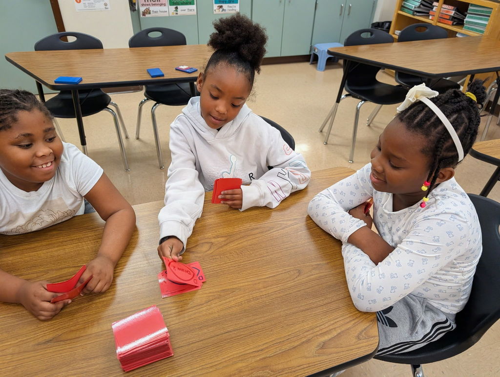 Three students playing cards