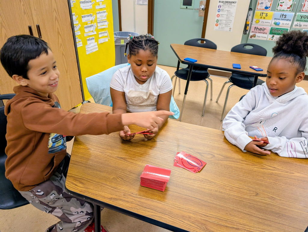 Three students playing cards