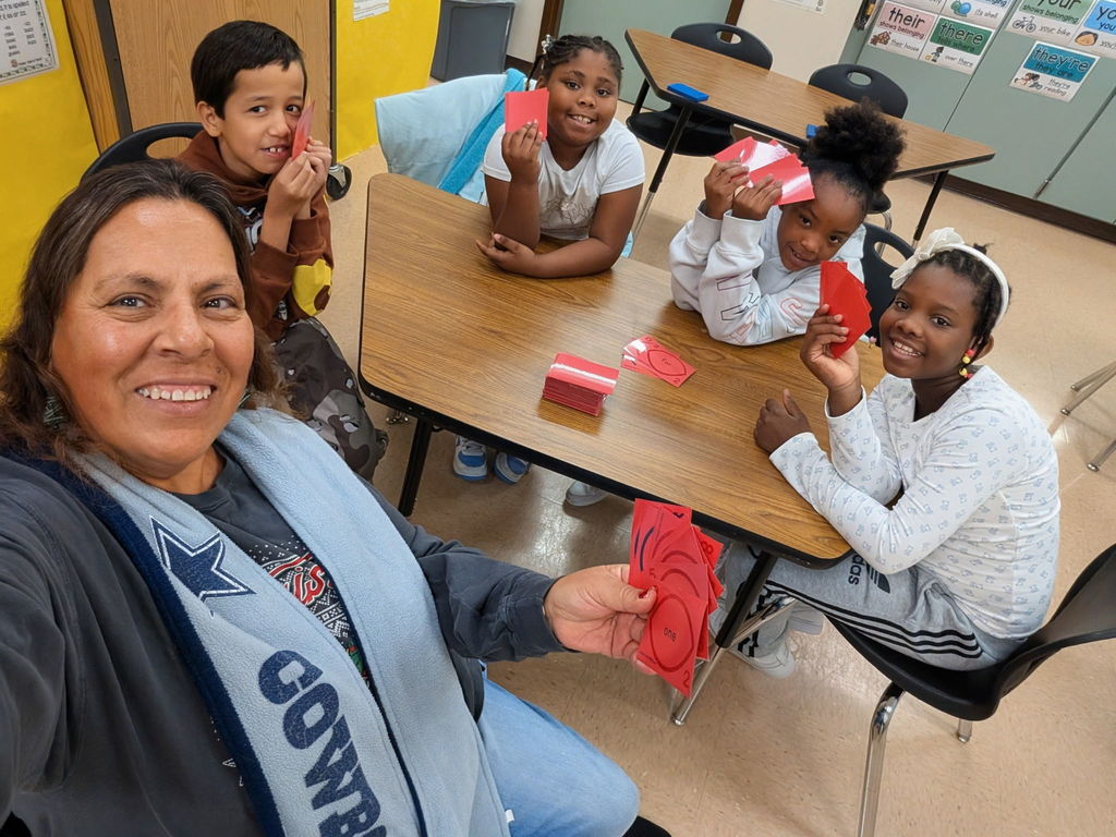 Students and teachers playing cards