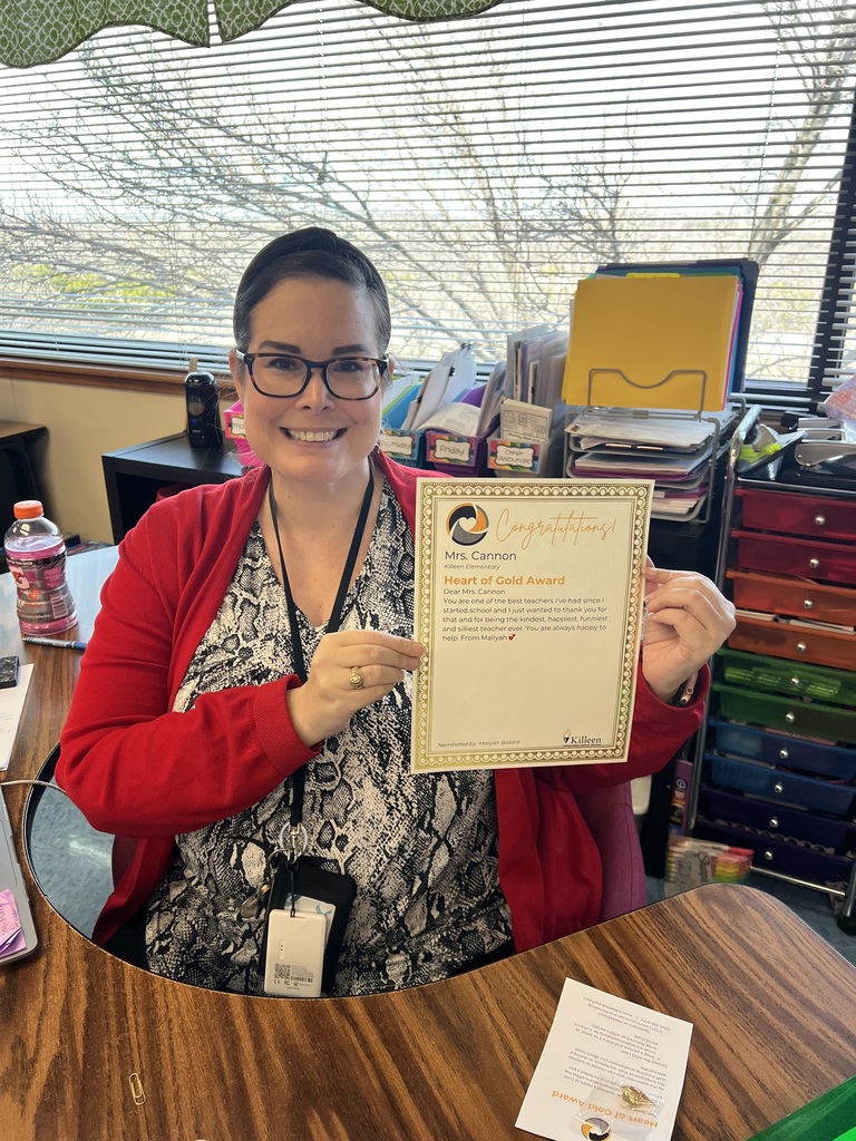 Teacher holding up an award