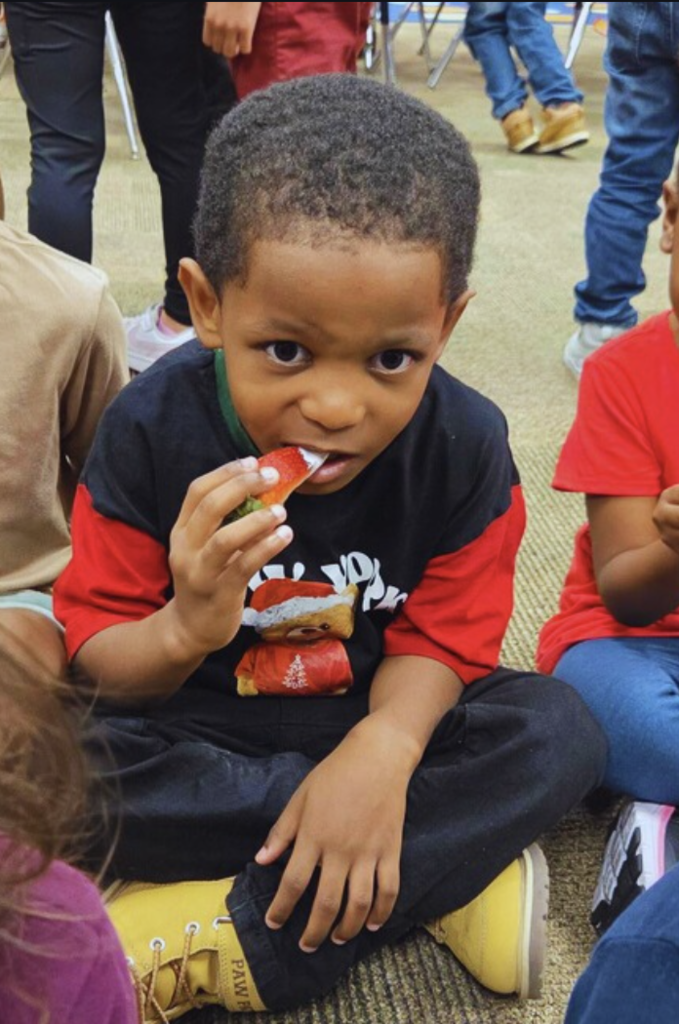 child eating strawberry