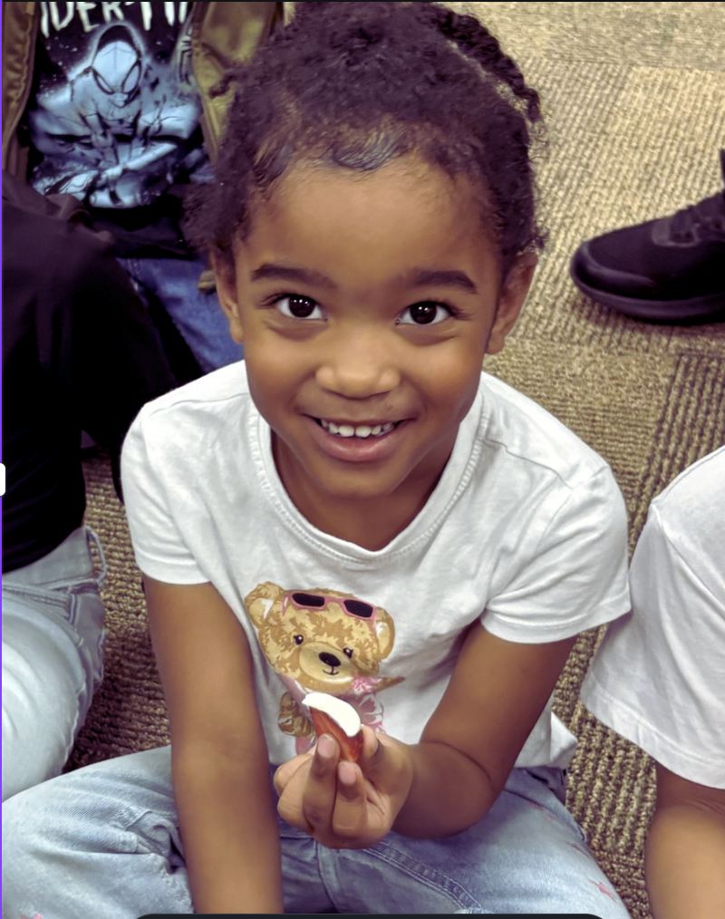 child holding a strawberry