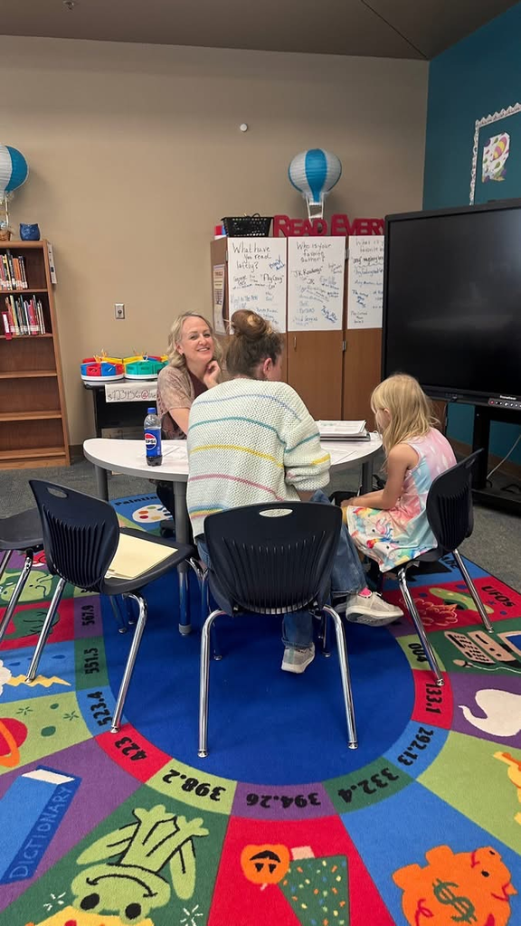 colorful rug  teacher parent and student sitting at table