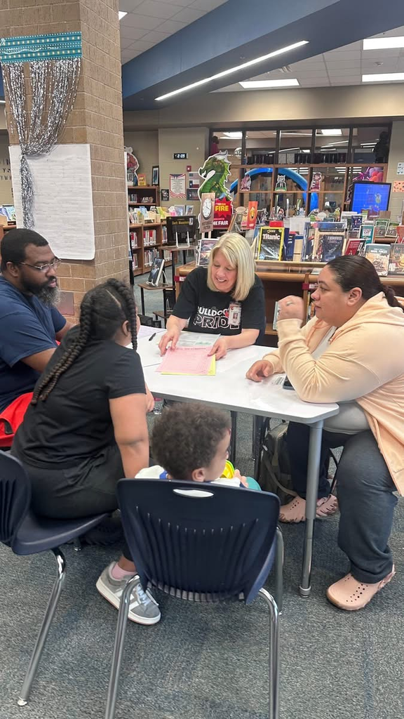 teacher with student and parents in conference 