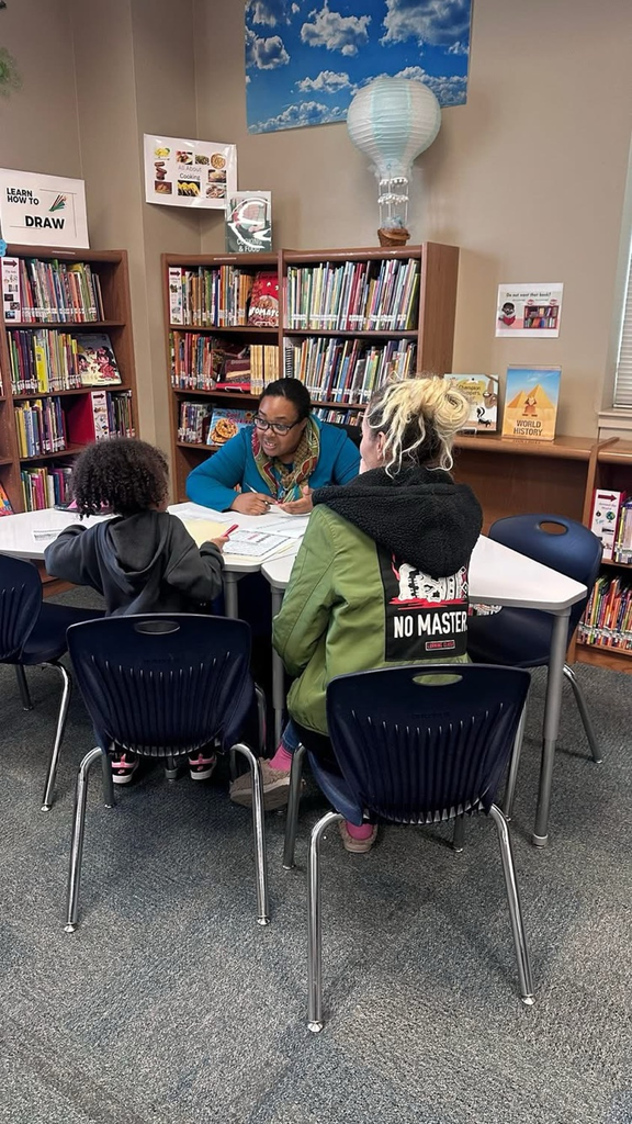teacher with parent and student in conference