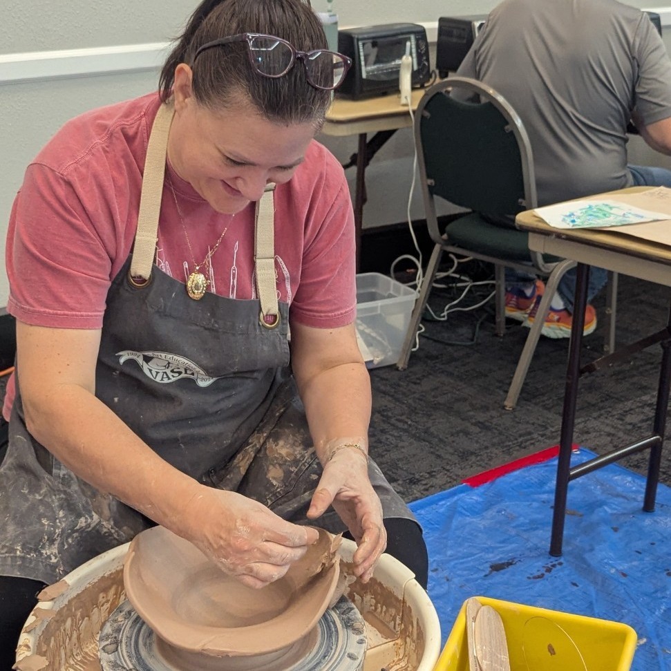 Julie Smith makes a bowl on a potter's wheel