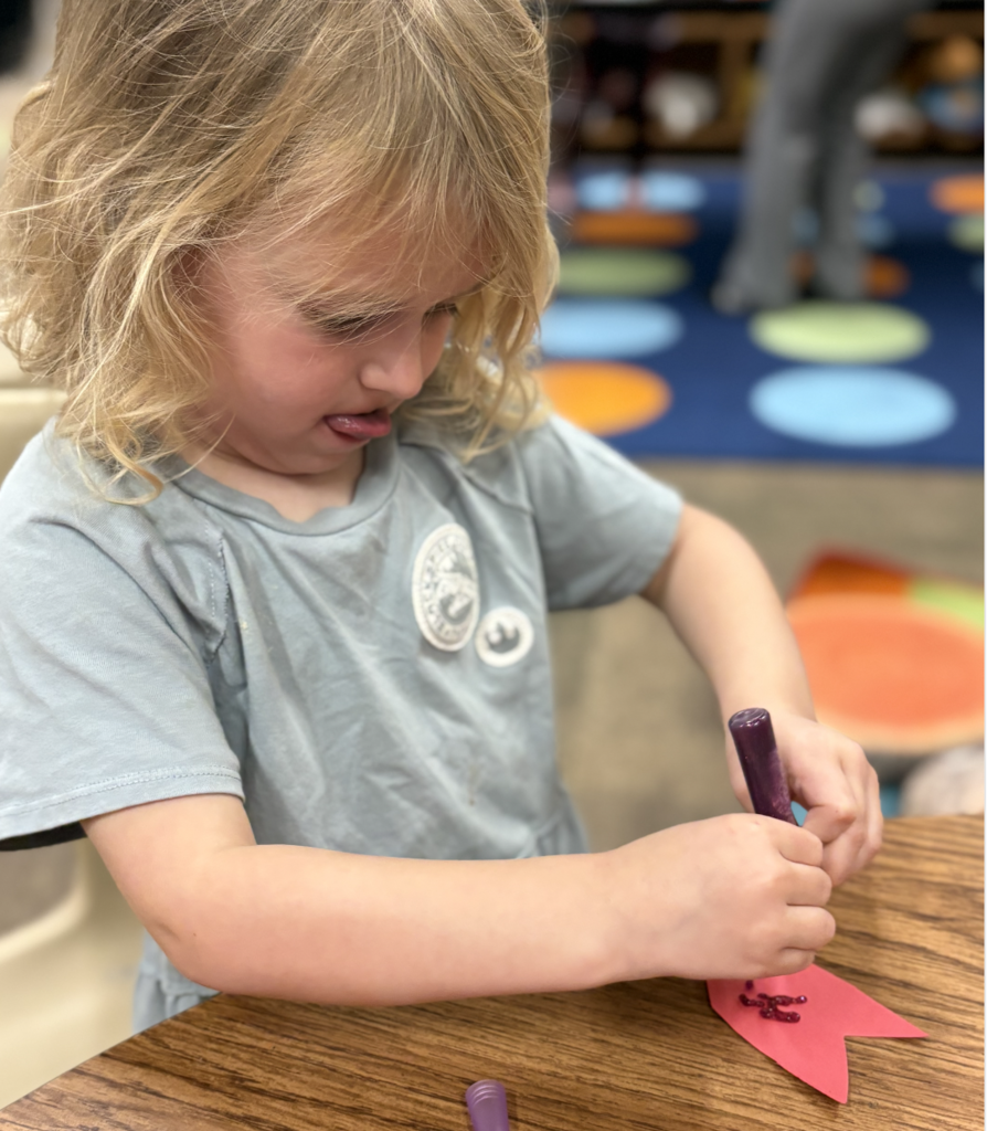 Student creating a heart