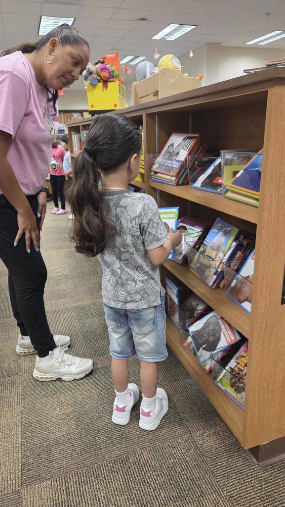 kids looking at books on a shelf