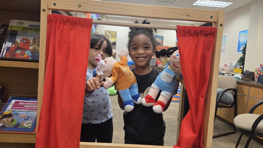 Kids playing with a puppet theater