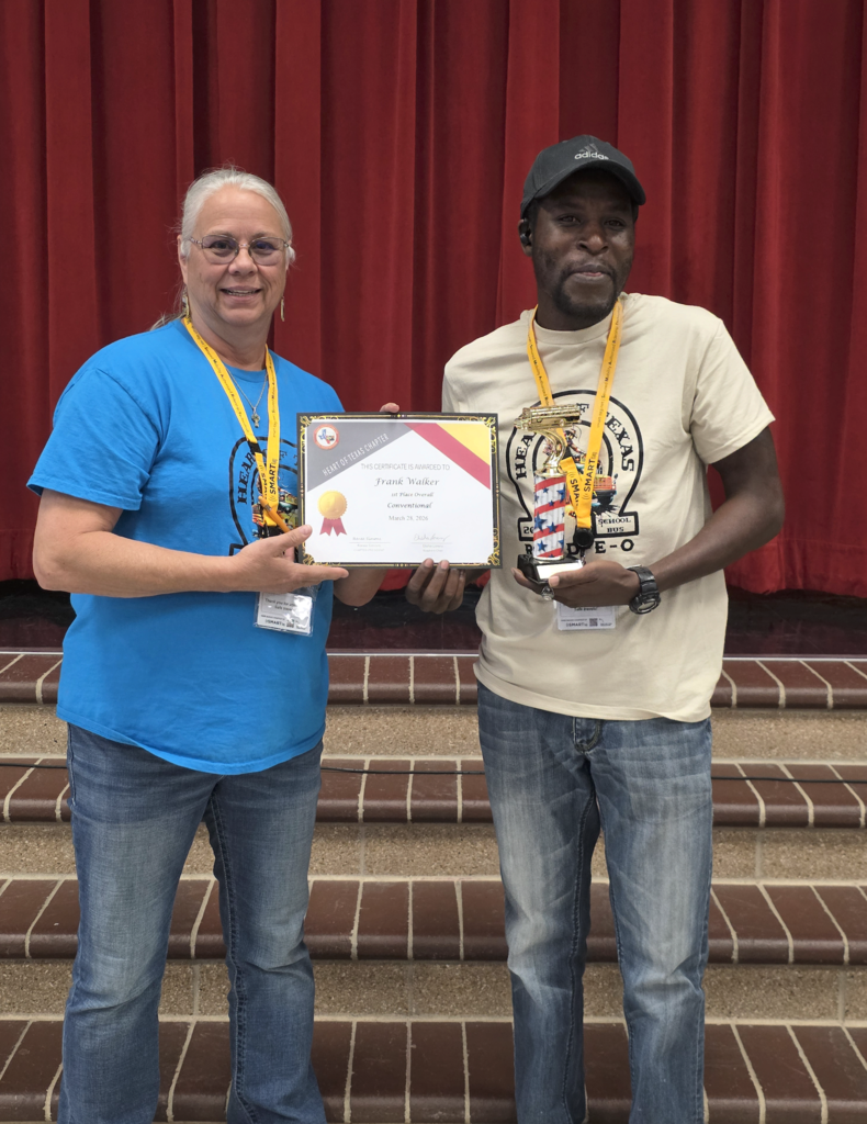man holding trophy and certificate smiling next to woman