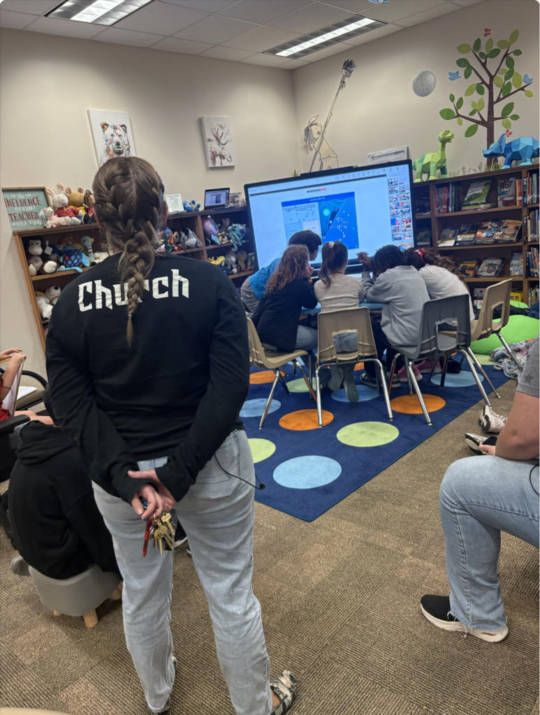 teacher watching students work