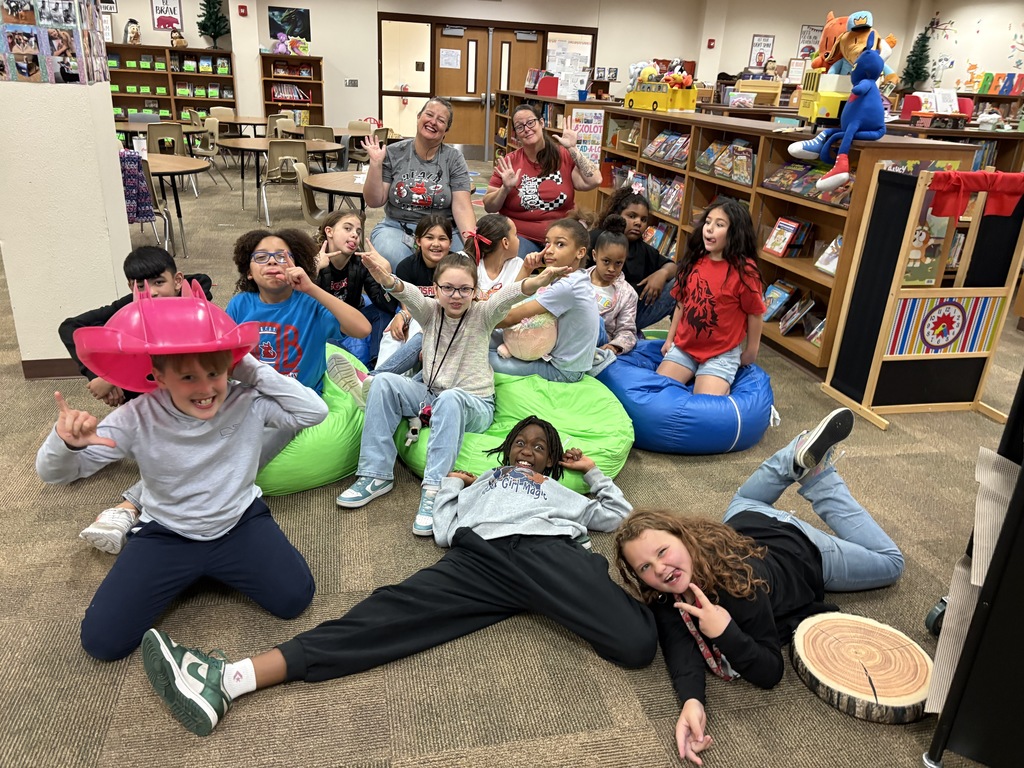 Students and teachers posing for a silly picture.