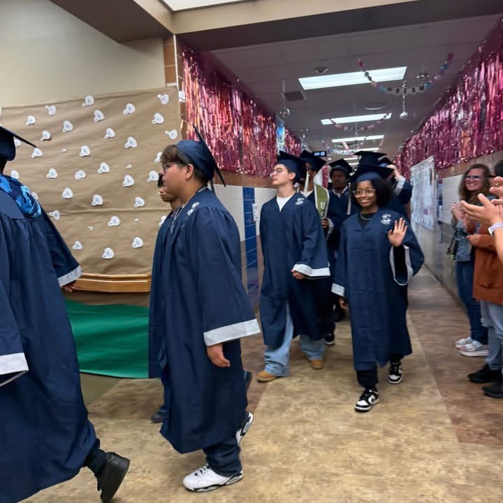 students wearing cap and gown 