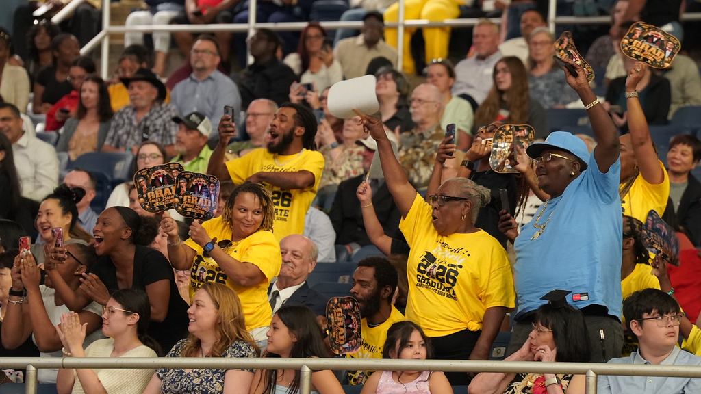 photo of parents in a crowd celebrating