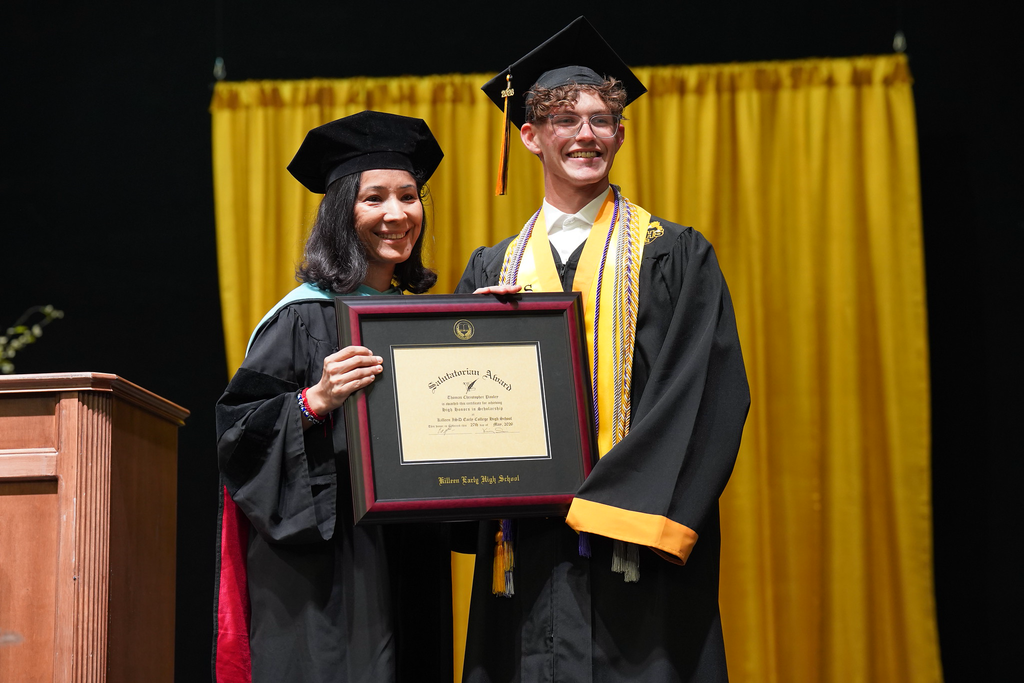 woman and young man smiling holding a certificate