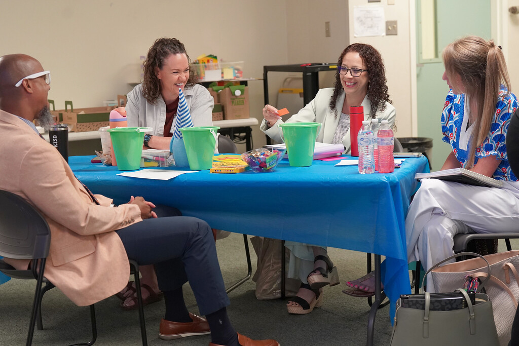 group of people at a table smiling and laughing