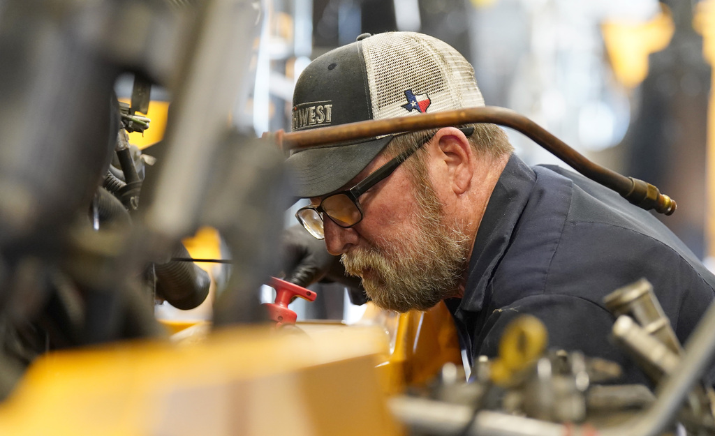 KISD employee works on a bus engine