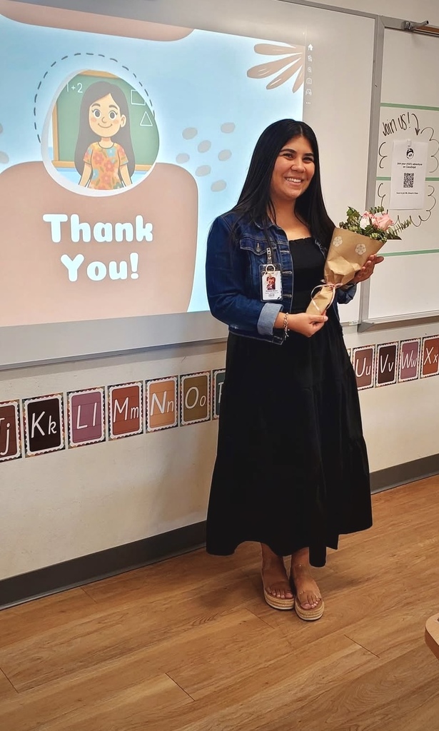 woman holding a bouquet of flowers smiling at the camera